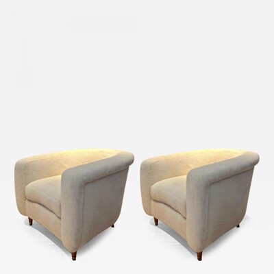 Jean Royere pair of lounge chairs covered in wool faux fur